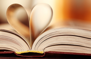 Open book with heart shaped from pages.
