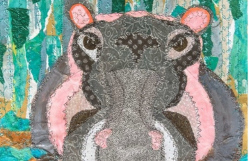 sewn paper collage of hippo in water