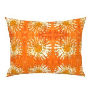 orange pillow with white flower pattern