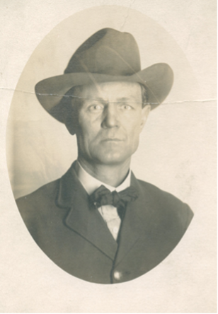 Historical photo of Mox A Horger (white man in bowtie and suit with a hat on)