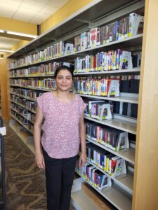 woman standing in front of library shelves