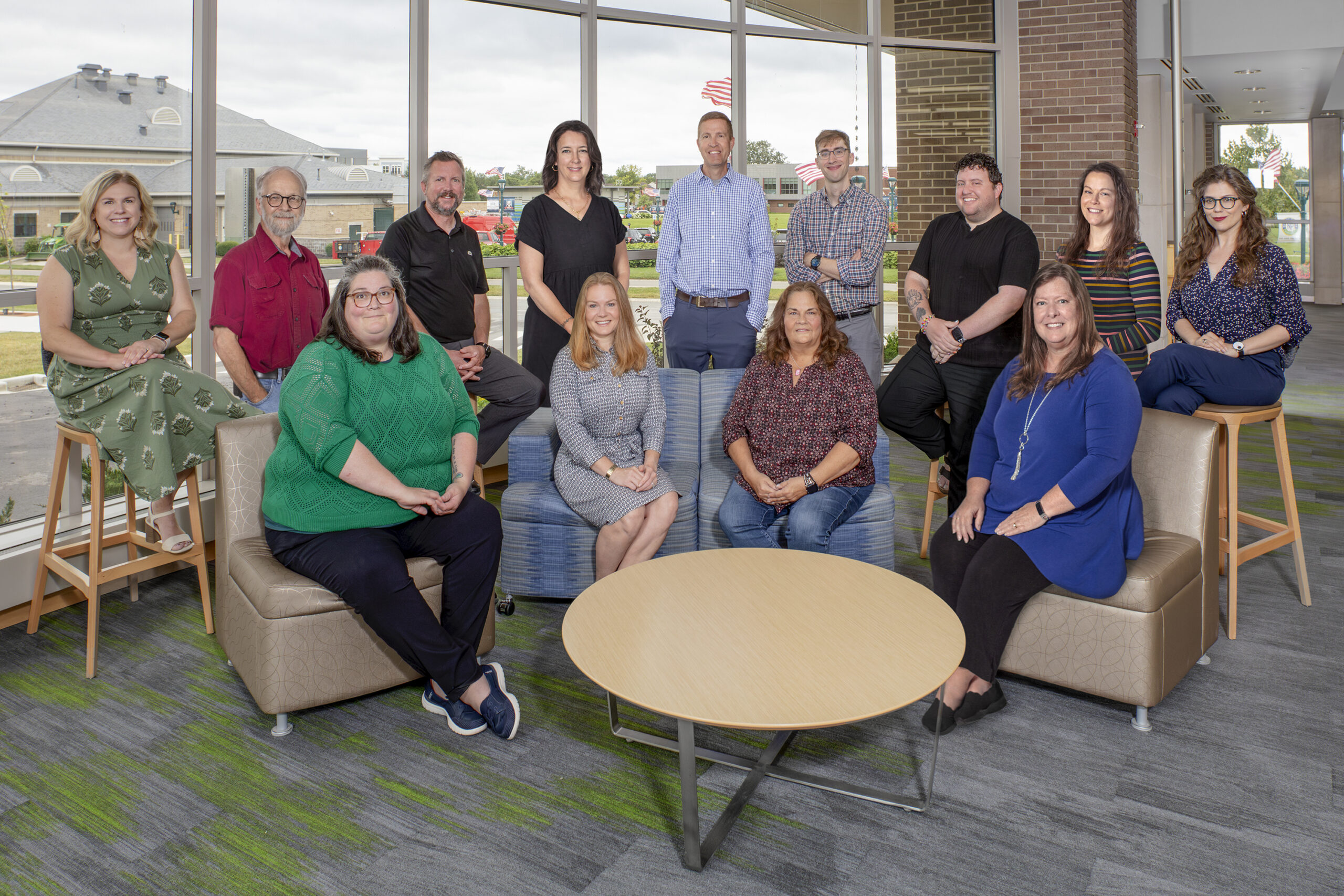 Group of 13 people posing for photo