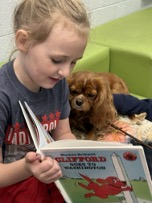 girl reading to dog