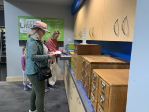 People looking through cabinets for seed packets