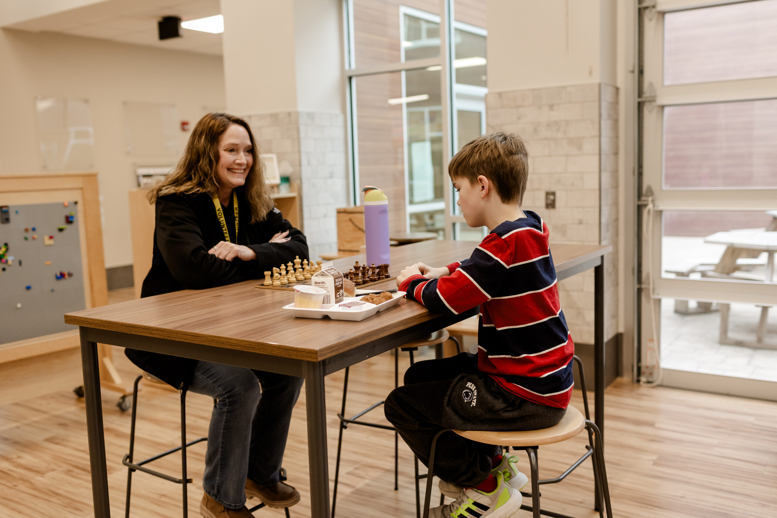 Woman and boy playing chess