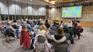 seated people listening to a presentation