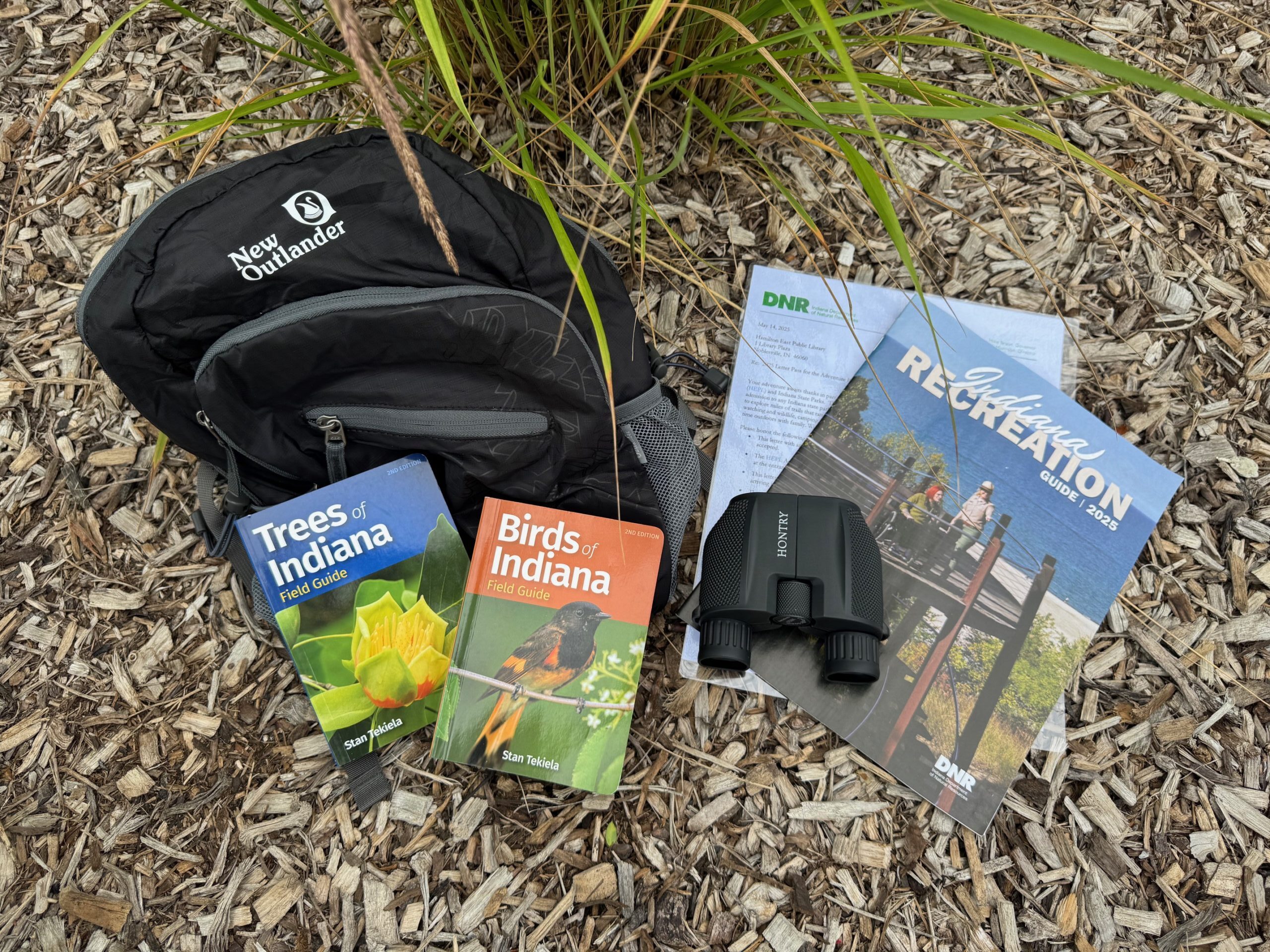 backpack with guide books and binoculars