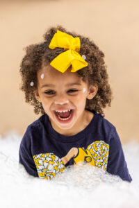 girl smiling with foam bubbles