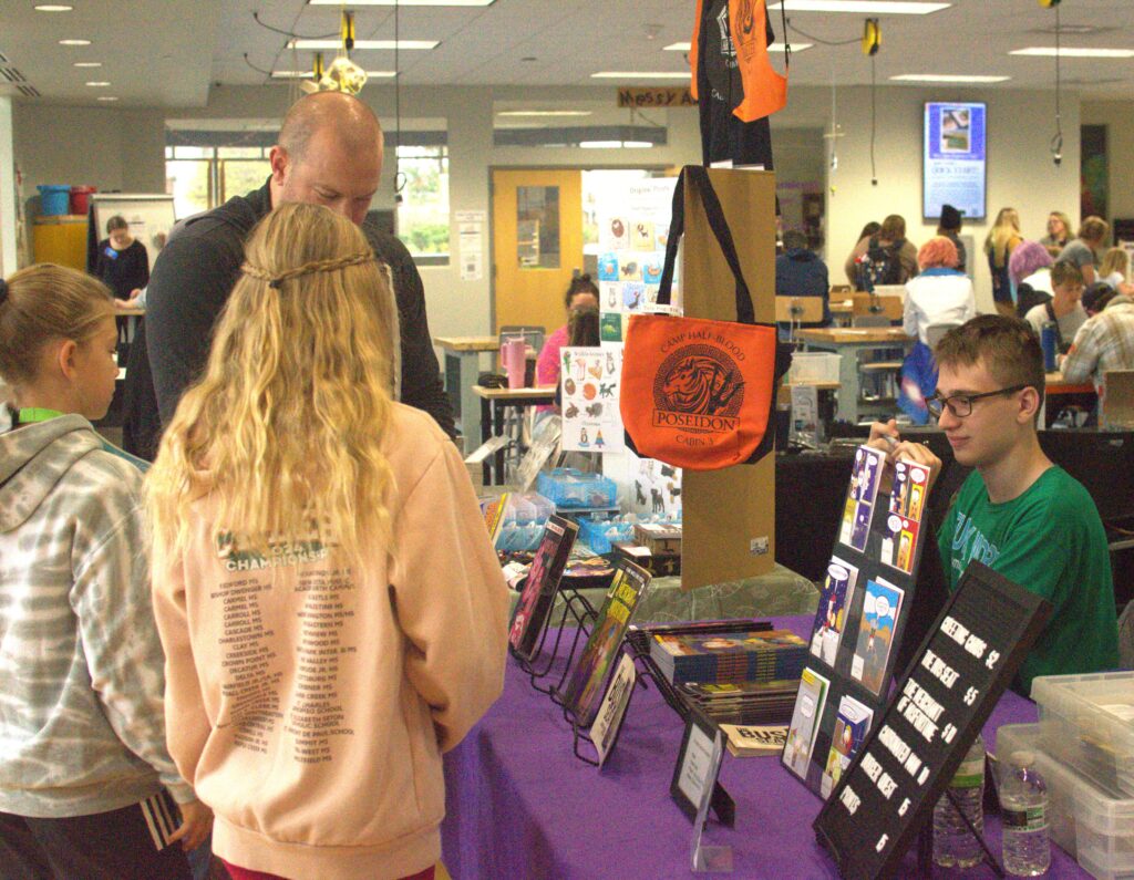 family looking at merchandise on a table