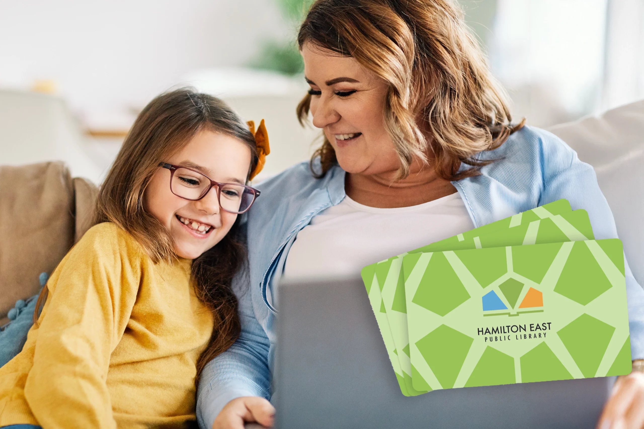 Mother and daughter on computer signing up for library card