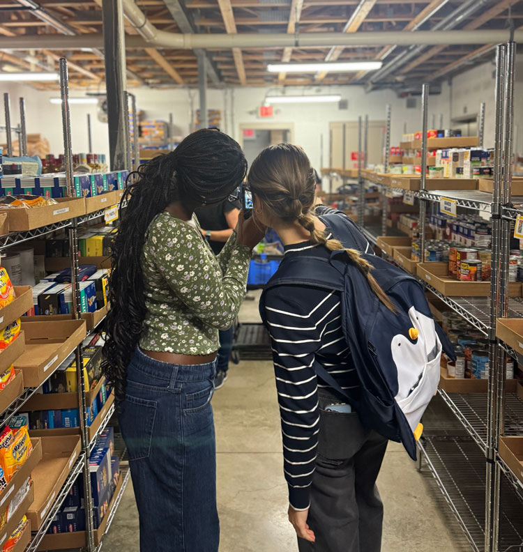 Two girls looking through a camera