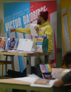 man standing behind table and pointing