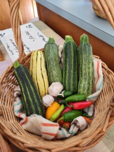 basket of squash, peppers, and garlic