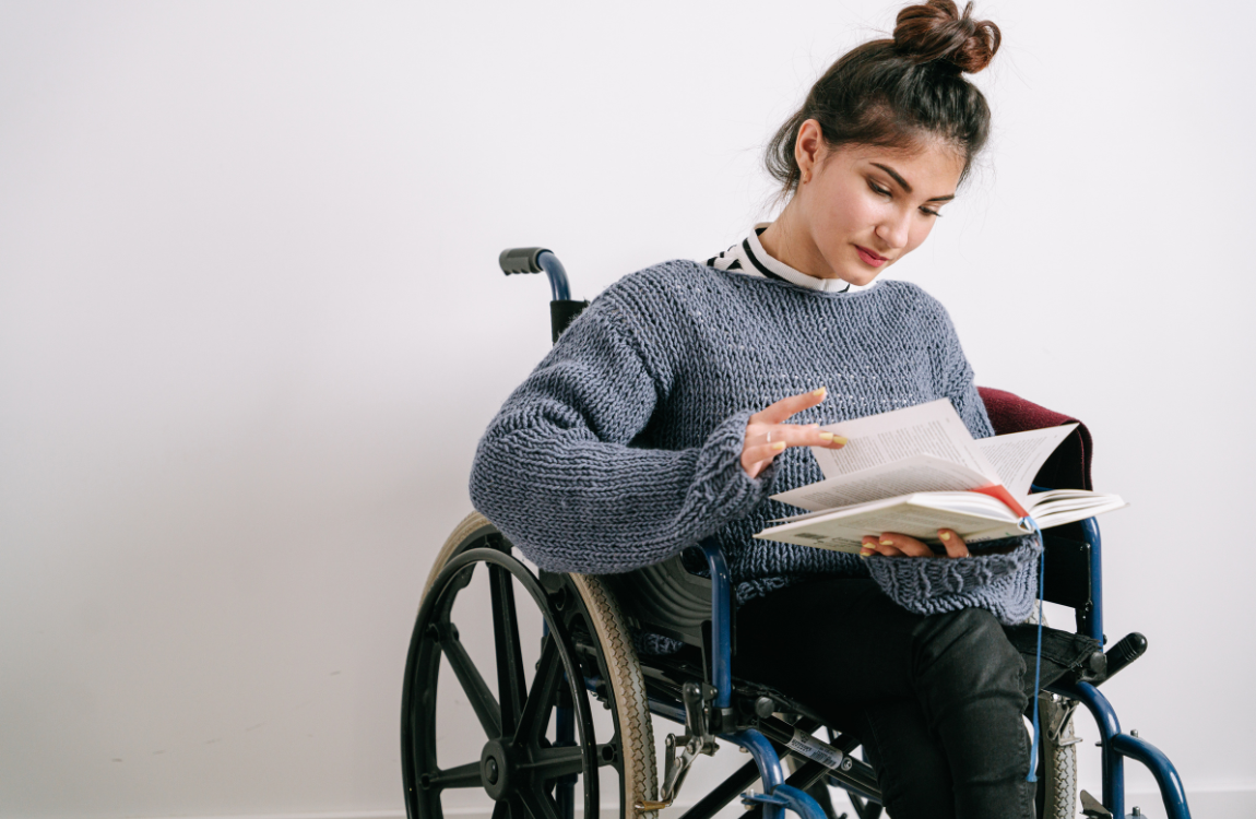 woman in wheelchair reading book