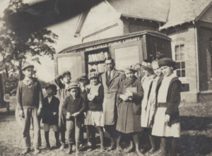 Image of the Bookmobile with students.