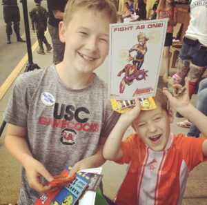 two children holding comics