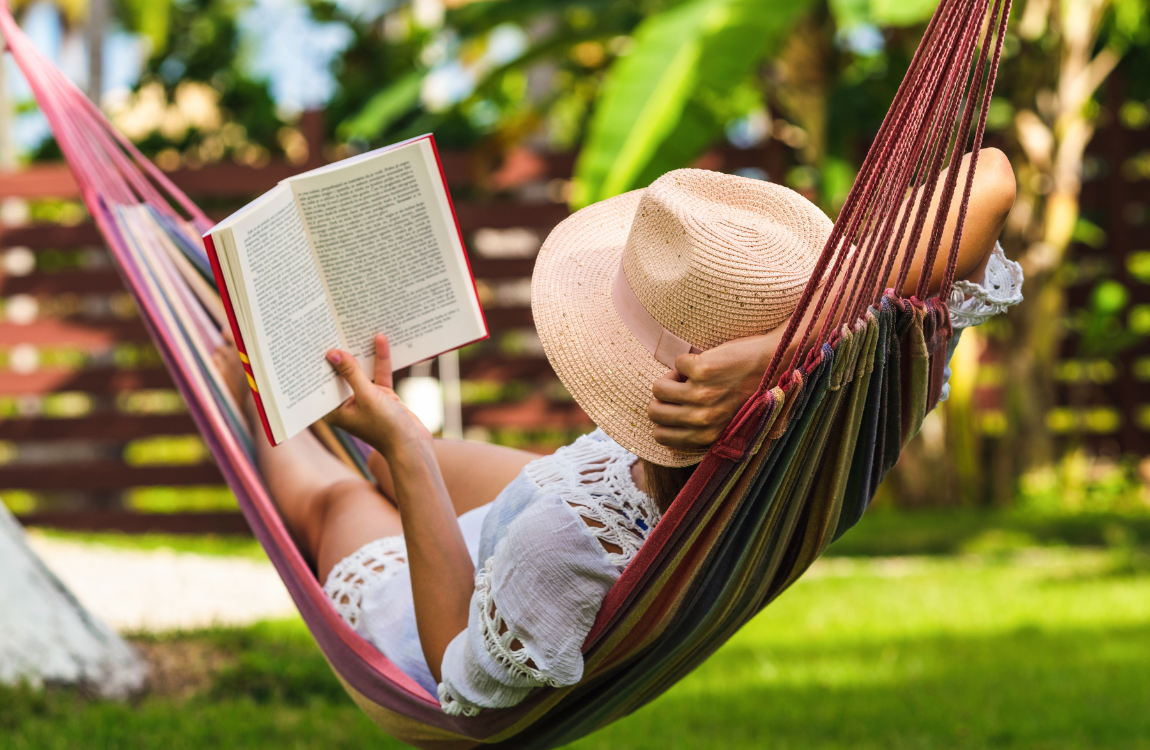 woman reading book in hammock