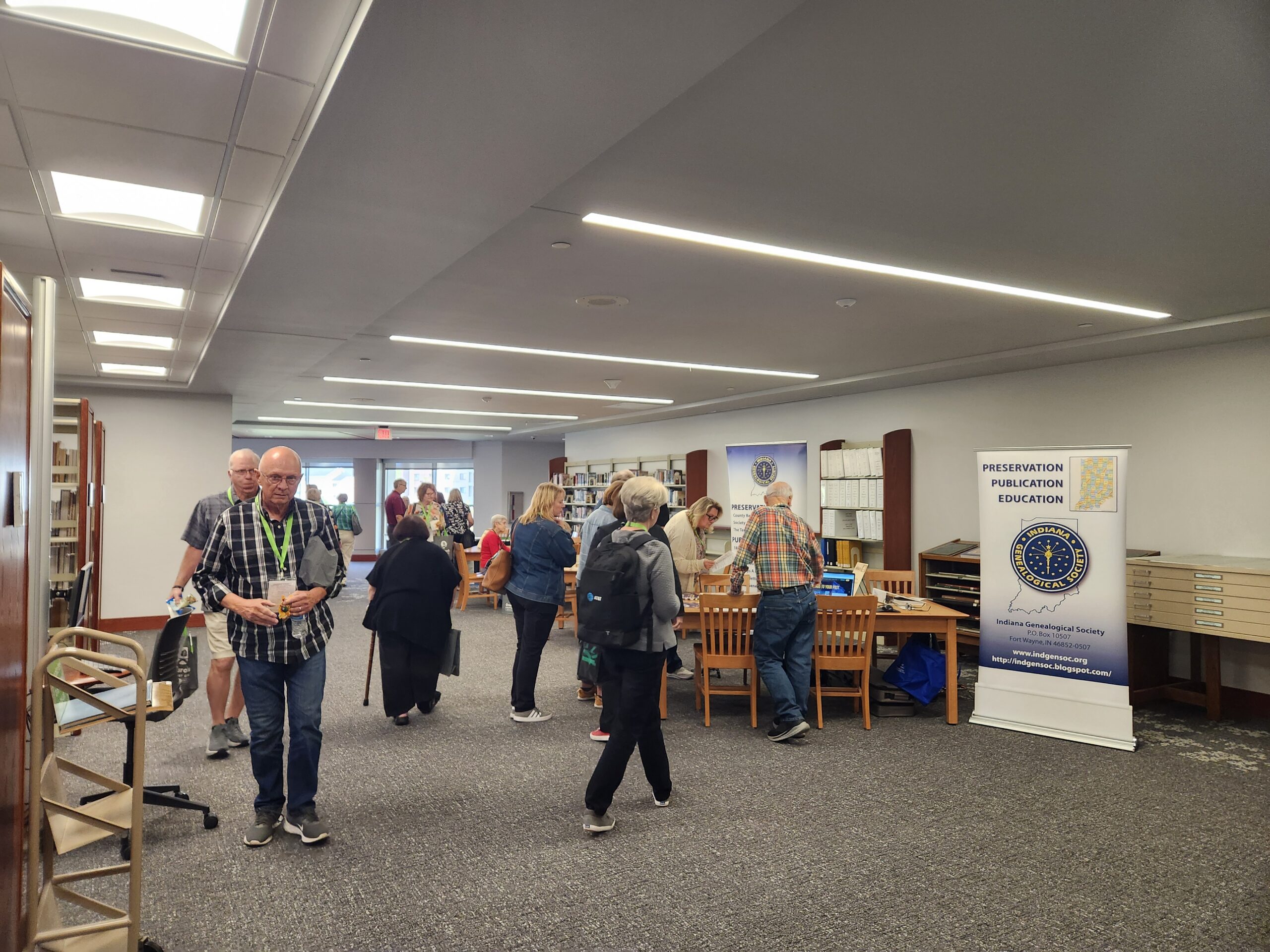 crowd of people walking amongst exhibit tables